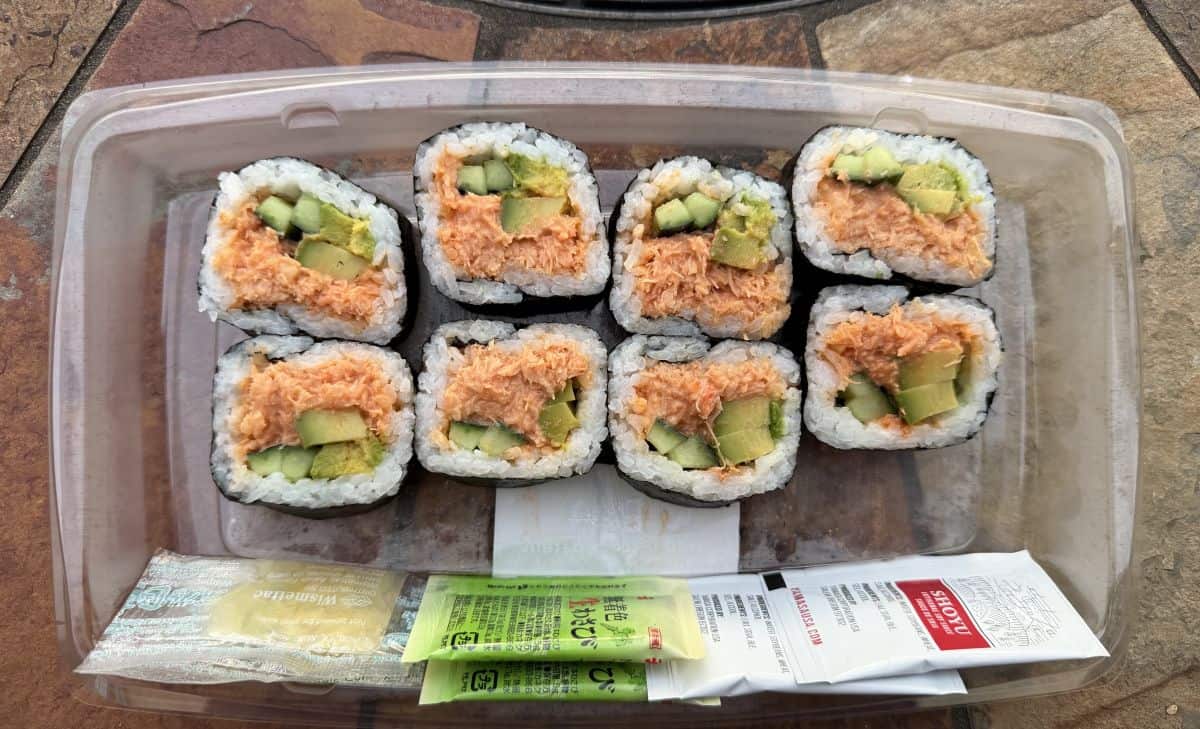 Image of eight spicy crab rolls in a plastic tray.