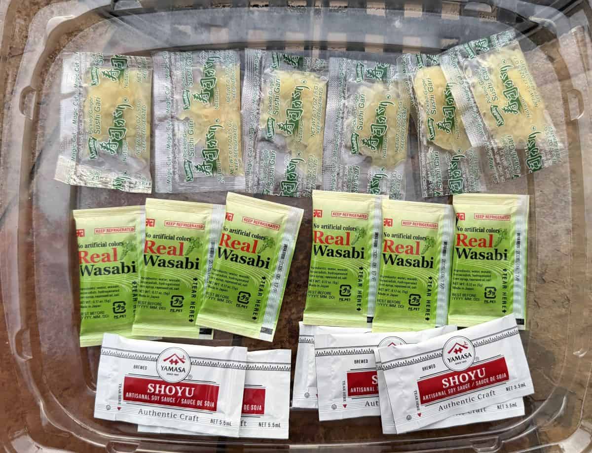 Image of all the different packets of soy sauce and ginger that come in the sushi at Costco.
