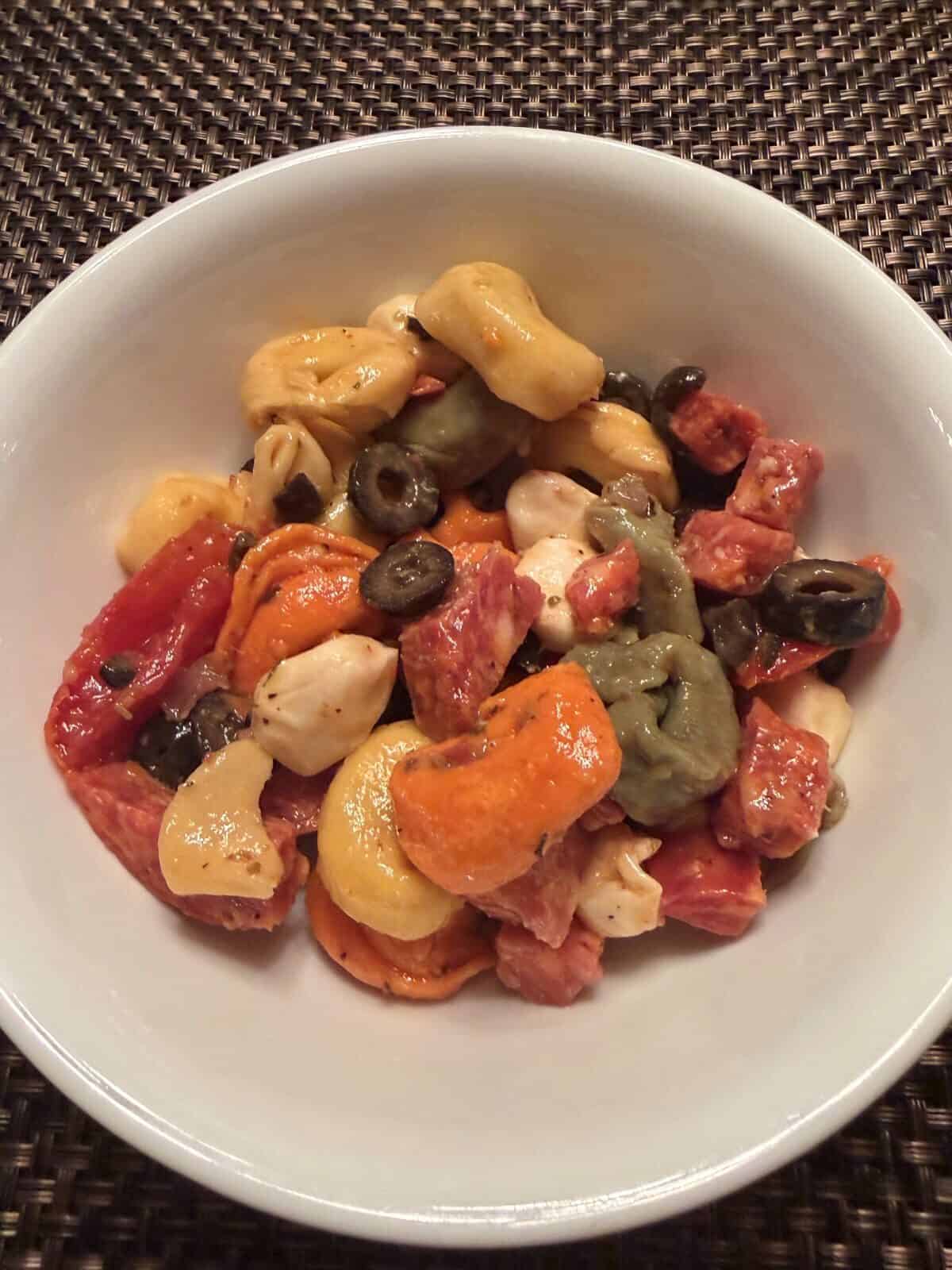 Top down image of a bowl of Costco Tortellini Pasta Salad.