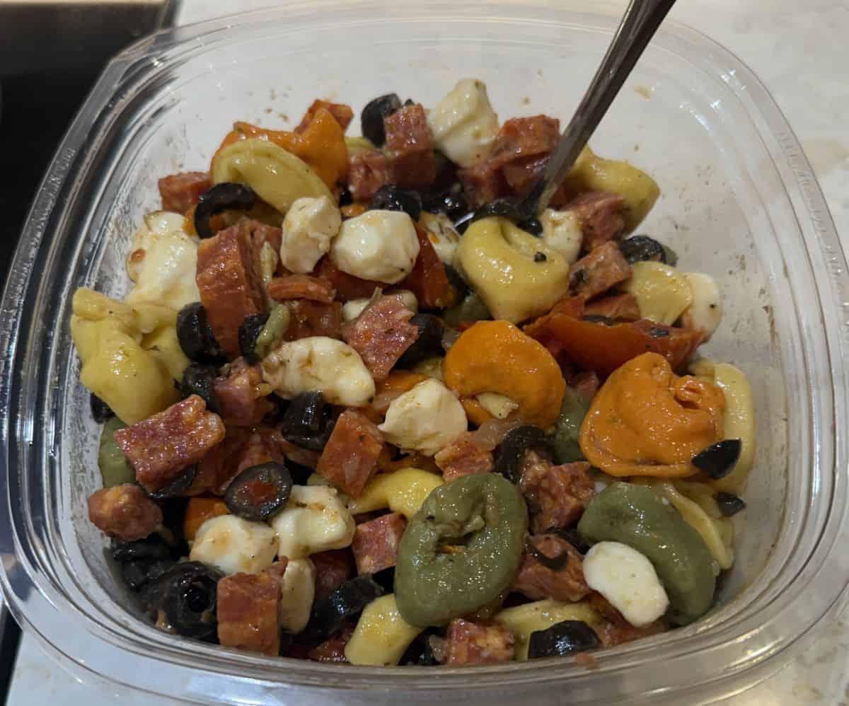 Top down image of a pasta salad container, opened with the lid off.