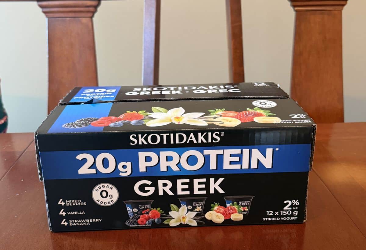 Image of the box of Costco Skotidakis Protein Greek Yogurt sitting on a table unopened.
