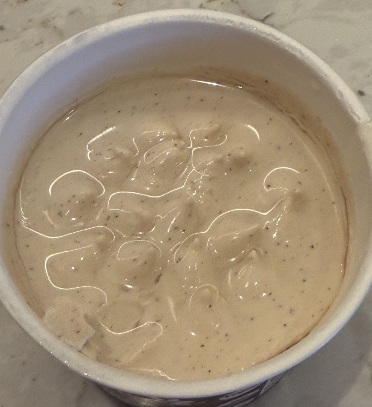 Top down image of the vanilla cinnamon Cocojune container opened so you can see what the yogurt looks like.
