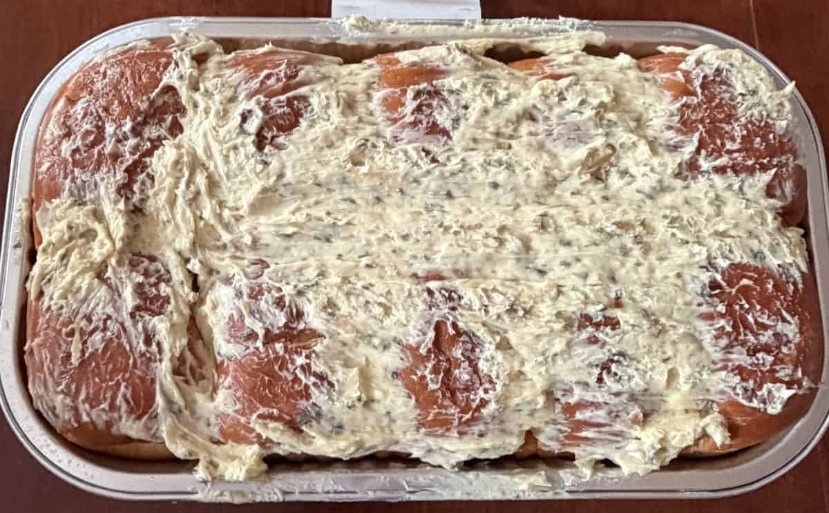 Image of the garlic bread in the tray before heating it without the lid on so you can see the garlic butter on top.