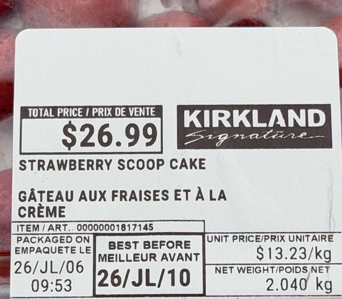 Closeup image of the front label on the cake showing the cost of the cake and best before date.