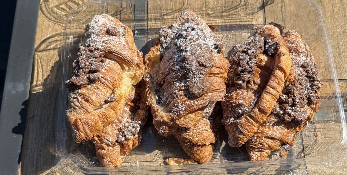 Top down image of the pack of croissants, open sitting on a table showing six croissants.