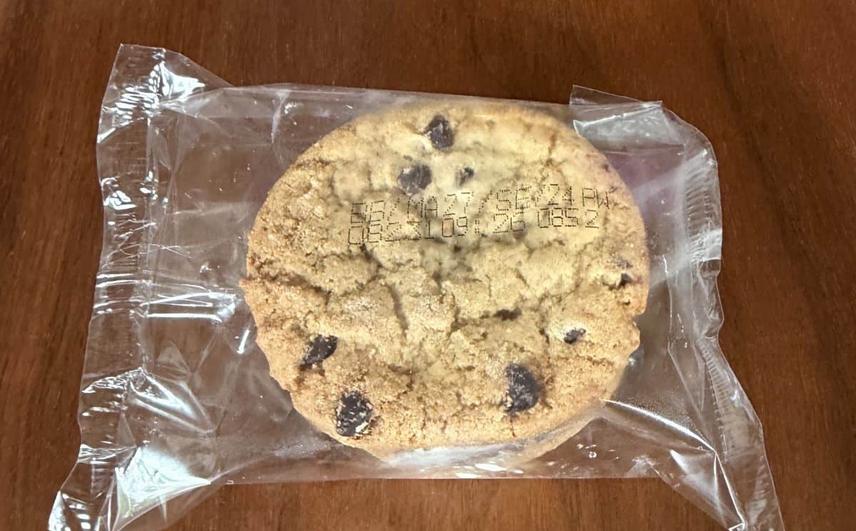Image of one individually wrapped ice cream sandwich unopened sitting on a table.