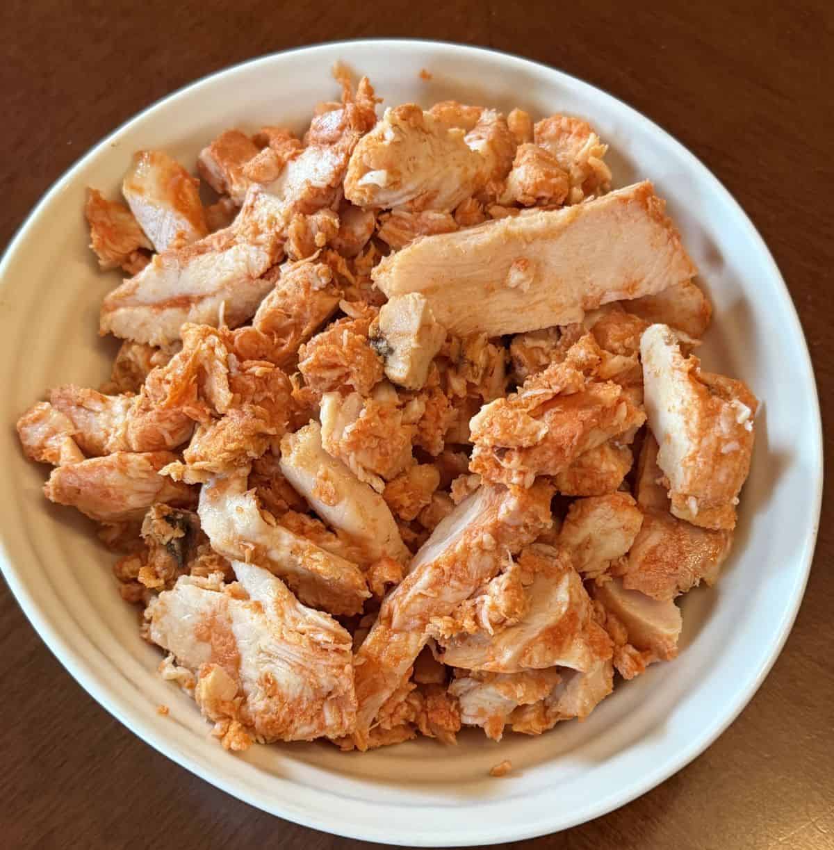 Top down image of the Costco Kirkland Signature Grilled Chipotle Chicken Served in a white bowl.