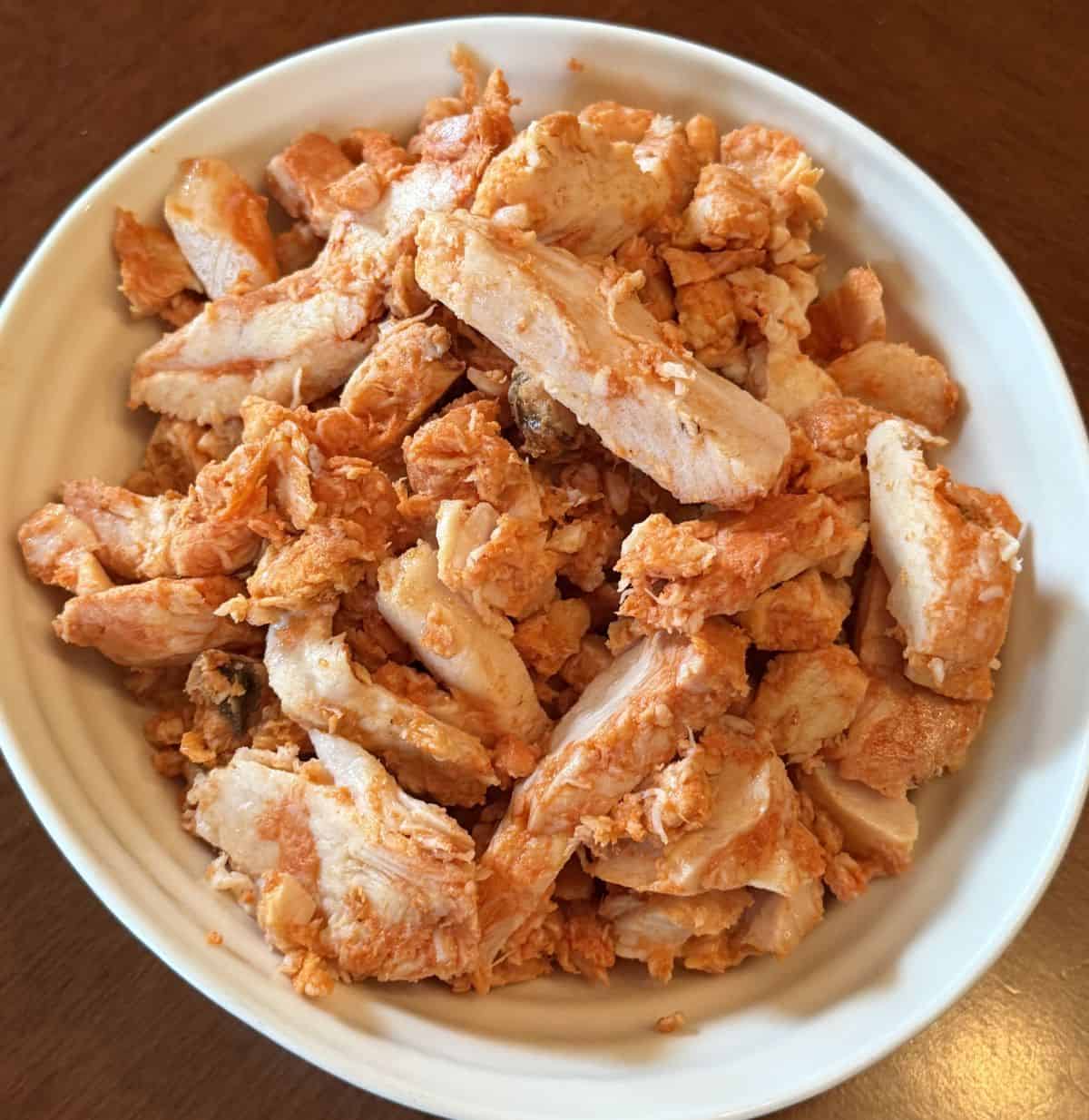 Closeup top down image of the Costco Kirkland Signature Grilled Chipotle Chicken served in a white bowl.