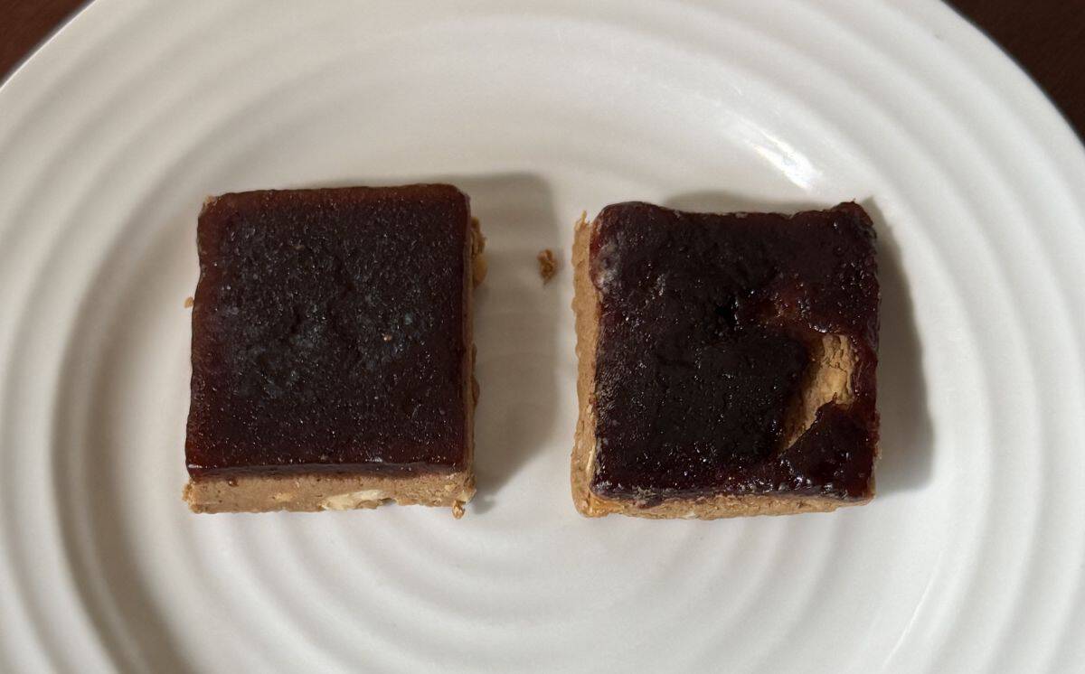 Top down image of two Mid-Day Squares opened and served on a white plate, there is grape and strawberry.