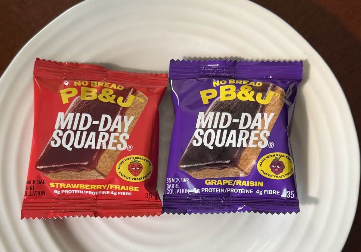 Image of the PB & J Squares individually wrapped and sitting on a white plate unopened.