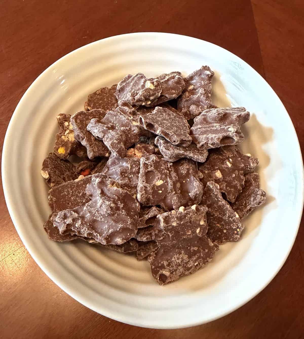 Top down image of a white bowl with the Reese's Pieces Bark served in the bowl.