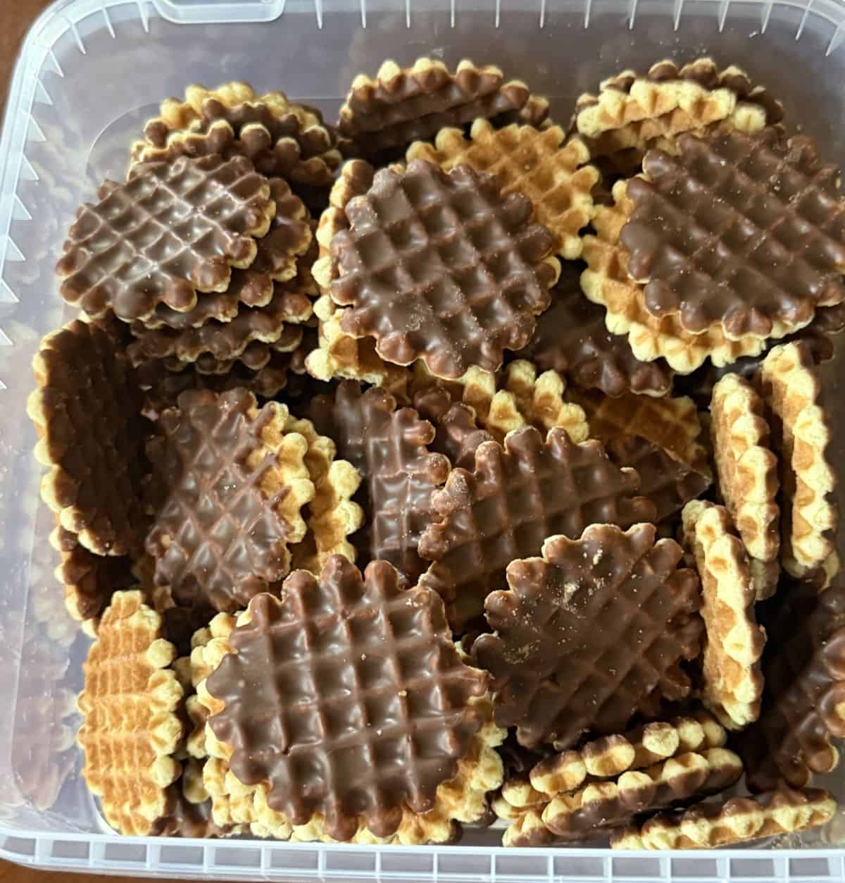 Top down image of the open container of the Wafflemeister Waffle Bites showing all the biscuits in the container.