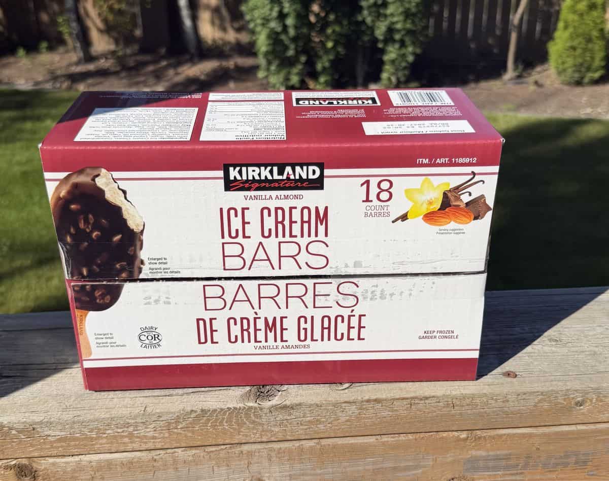 Image of the Costco Kirkland Signature Vanilla Almond Ice Cream Bars sitting on a deck outside unopened.