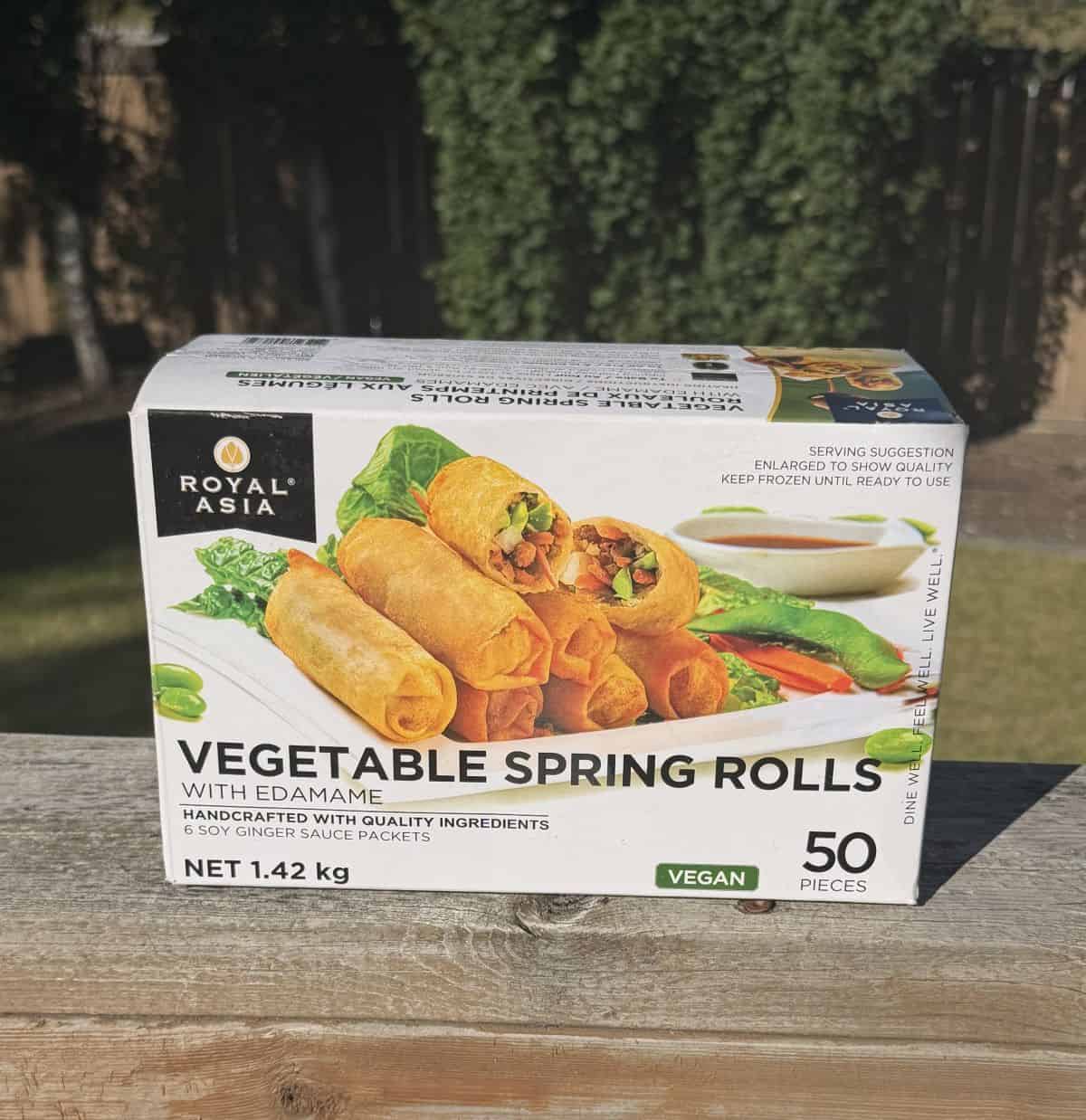 Image of the Costco Royal Asia Vegetable Spring Rolls box sitting on a deck outside unopened.