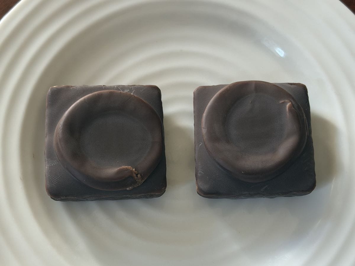 Image of two mini cakes unwrapped and served on a white plate.