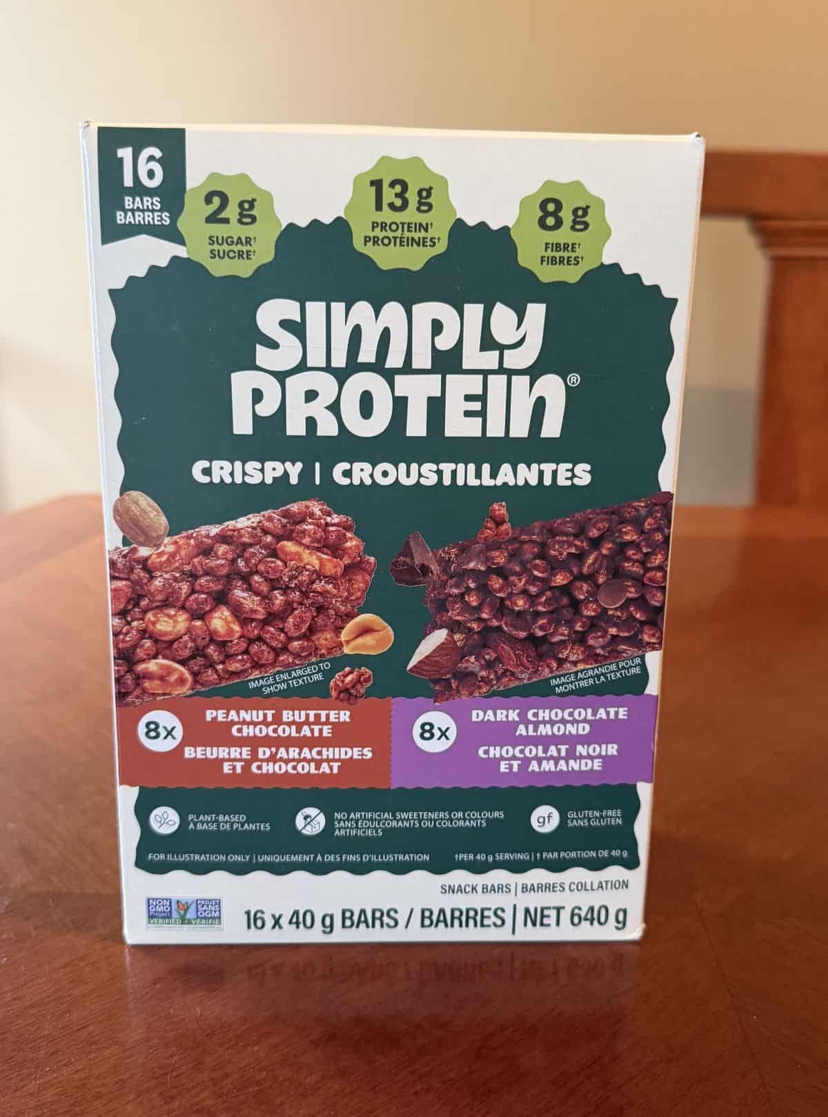 Image of the Costco Simply Protein Crispy Protein Bars box sitting on a table unopened.