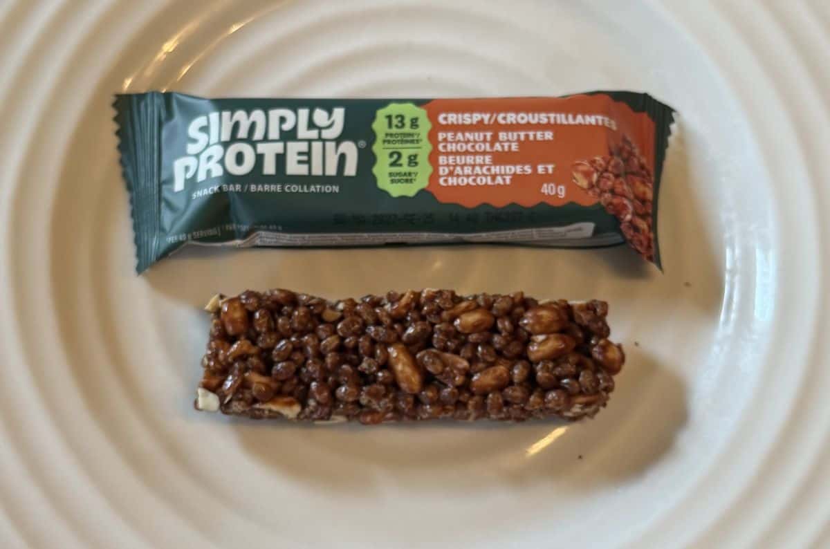 Image of one peanut butter chocolate bar unwrapped and served on a white plate.