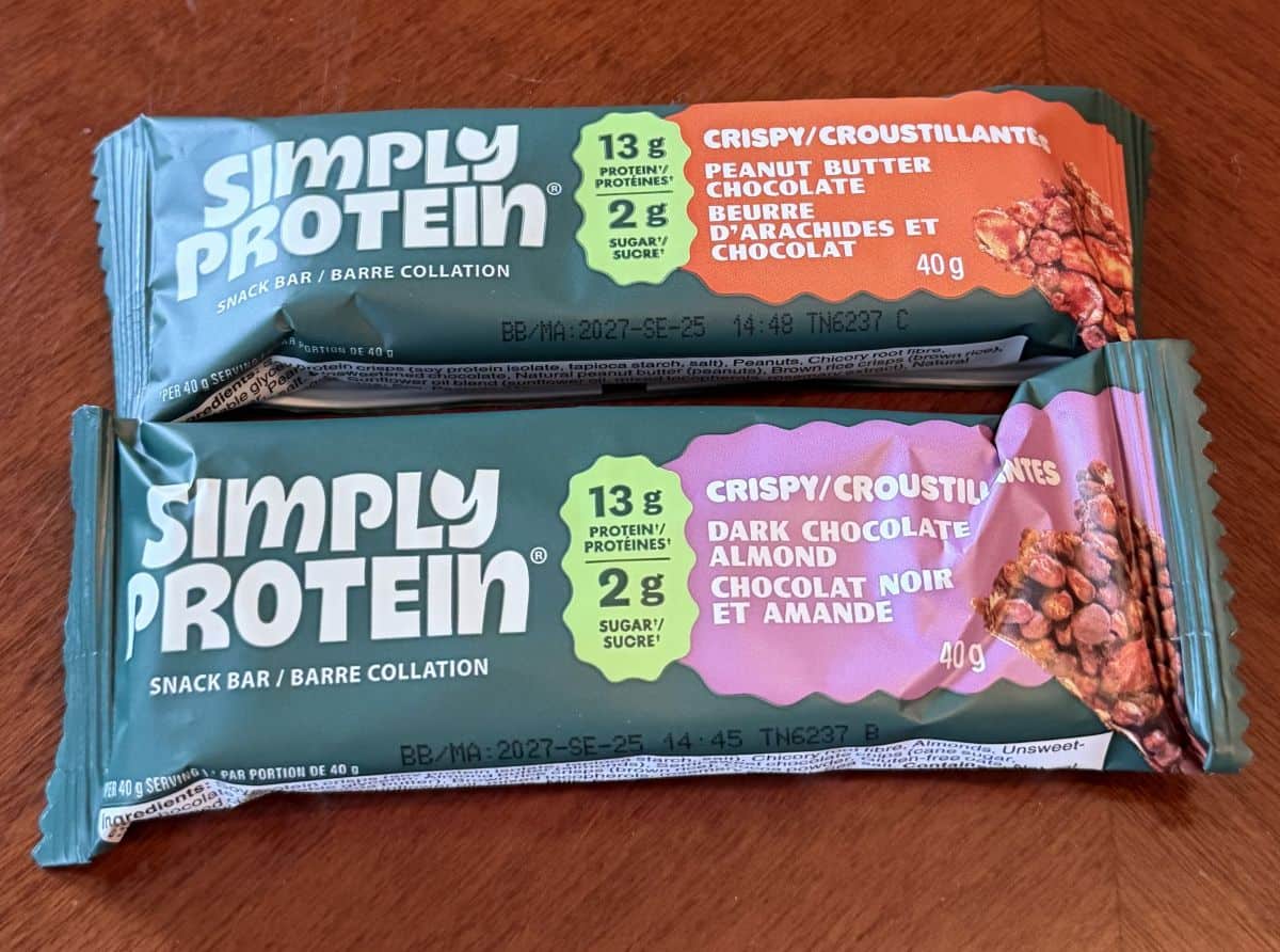 Image of two wrapped protein bars in two different flavors sitting on a table unopened.