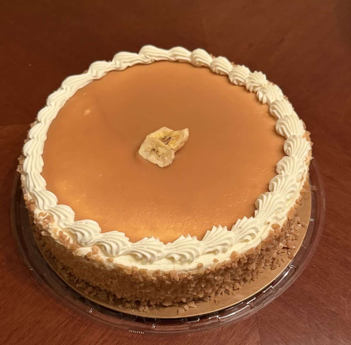 Top down image of the entire banana toffee cake sitting on a table without the lid on.