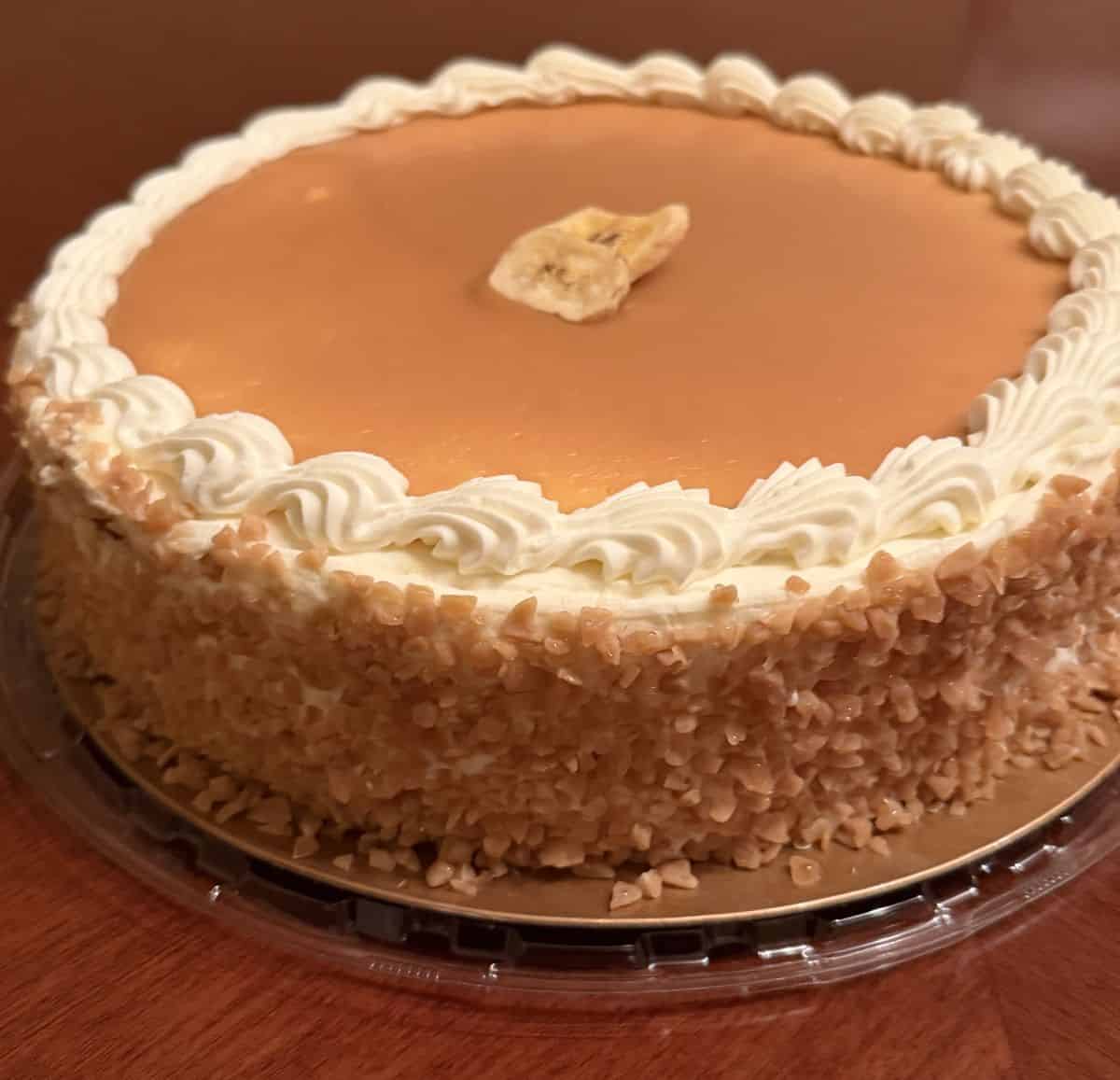 Sideview image of the banana toffee cake showing toffee crumble on the side of the cake.