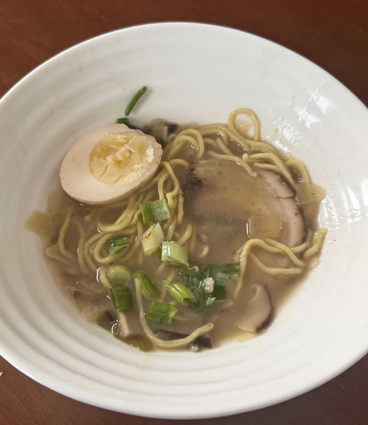 Top down image of a bowl of ramen served in a white bowl.