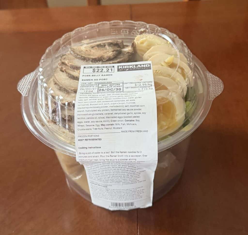 Image of the Costco Kirkland Signature Pork Belly Ramen container unopened sitting on a table.