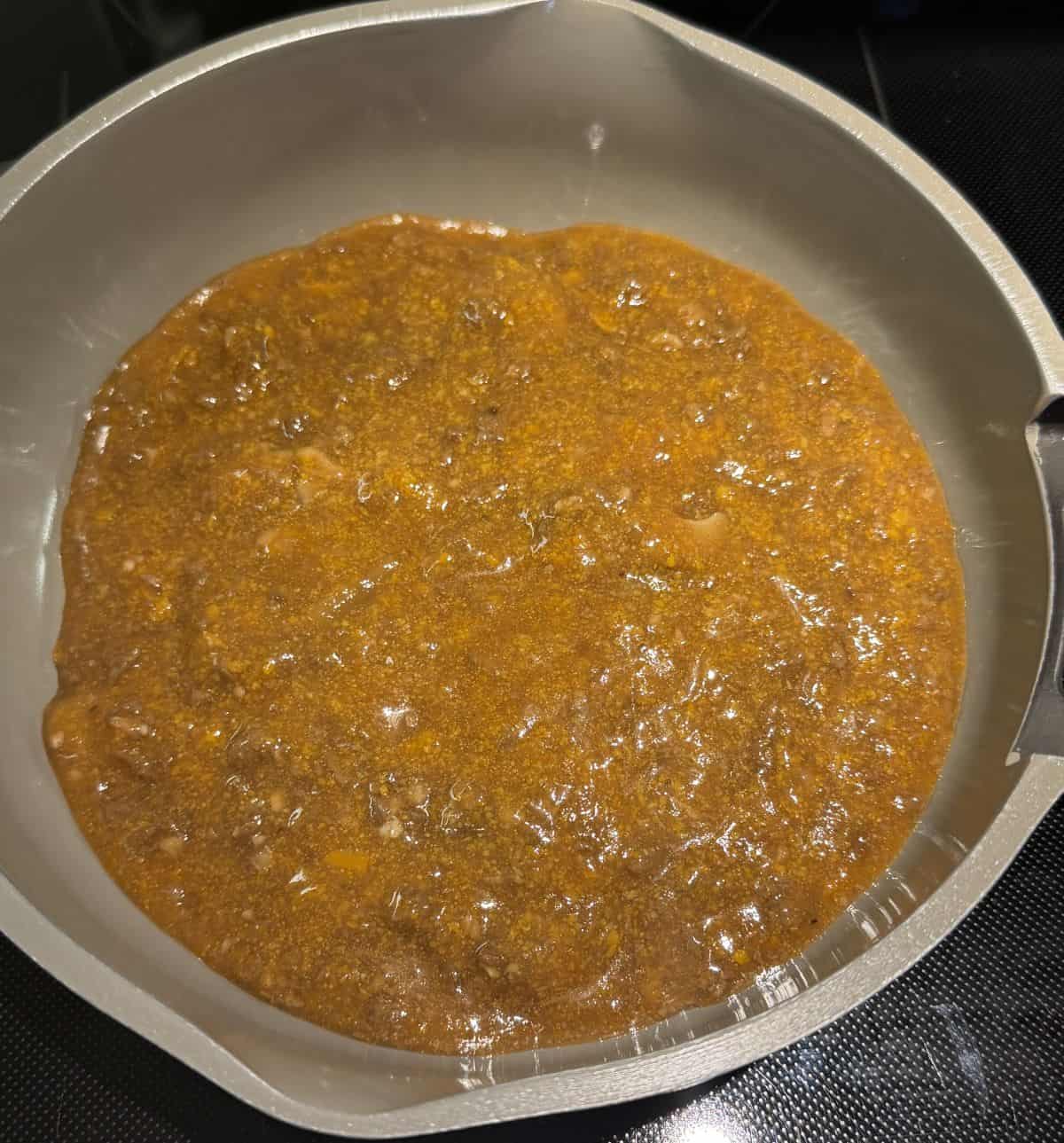 Image of the sauce being heated in a saucepan.